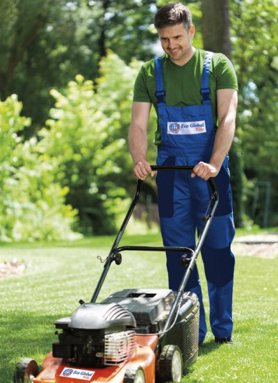 29942656 - man in work overalls mowing lawn, vertical